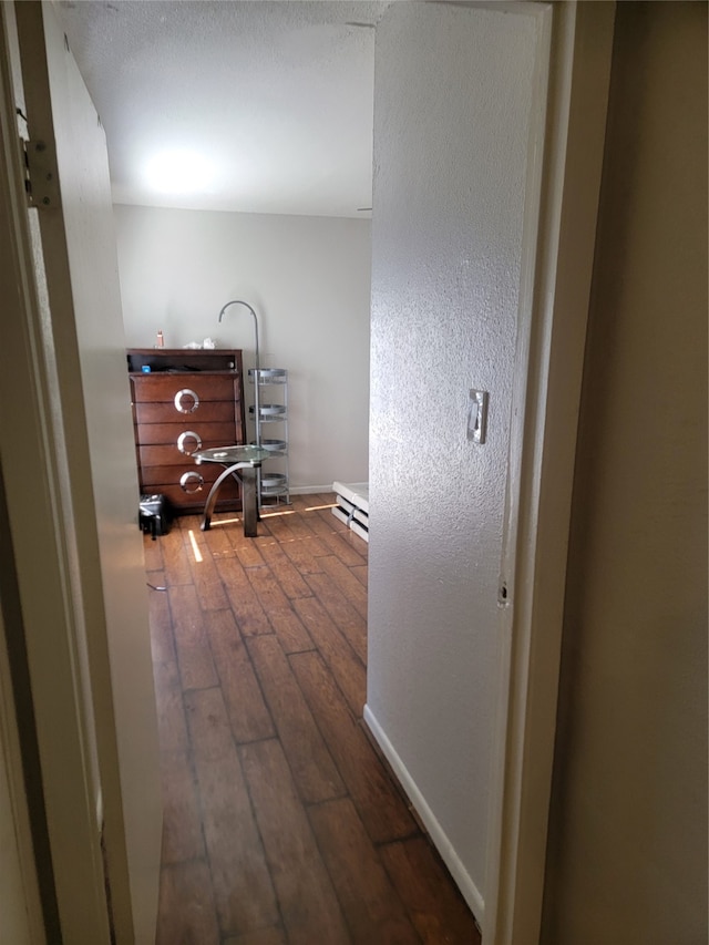 corridor with dark hardwood / wood-style flooring