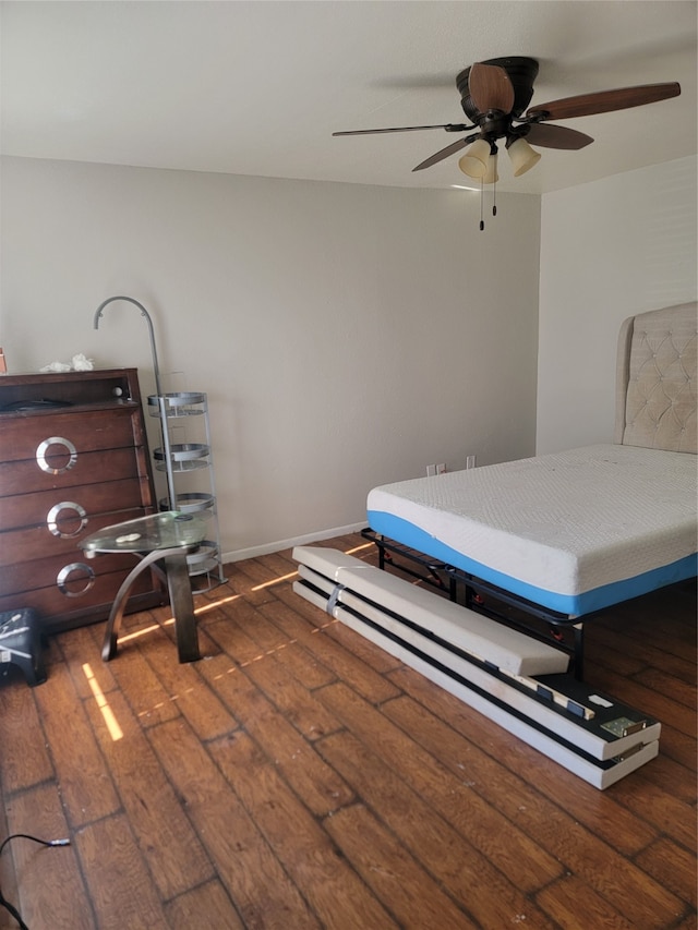 unfurnished bedroom with dark hardwood / wood-style flooring and ceiling fan