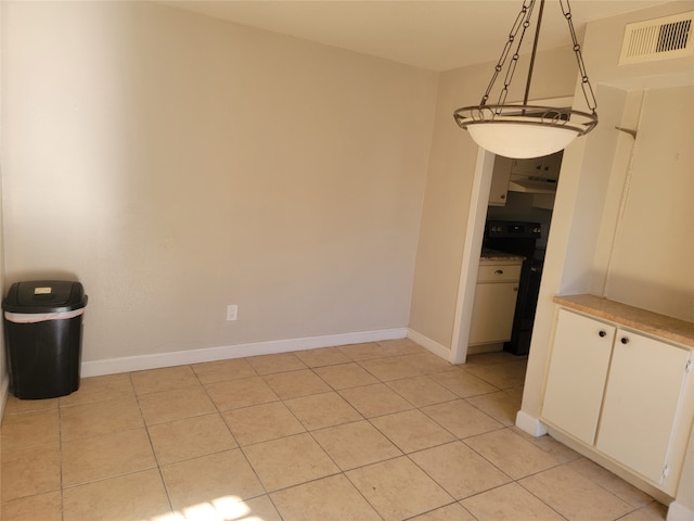 unfurnished dining area with light tile patterned flooring