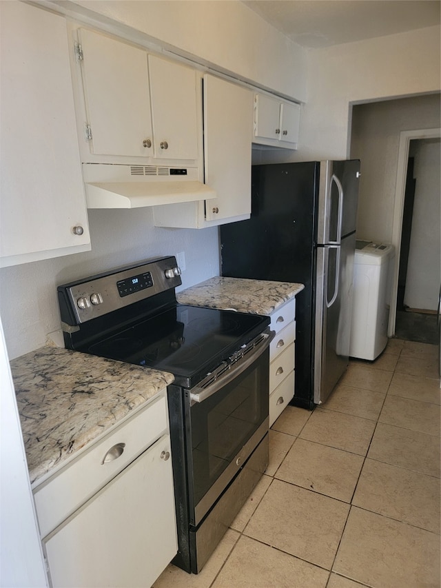 kitchen featuring white cabinets, light stone counters, washer / clothes dryer, stainless steel range with electric stovetop, and light tile patterned floors