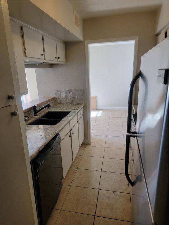 kitchen with white cabinetry, dishwasher, sink, fridge, and light tile patterned floors