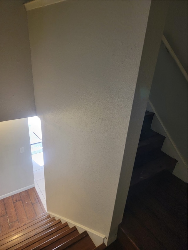 staircase with hardwood / wood-style floors