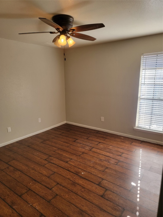 spare room featuring dark hardwood / wood-style floors and ceiling fan