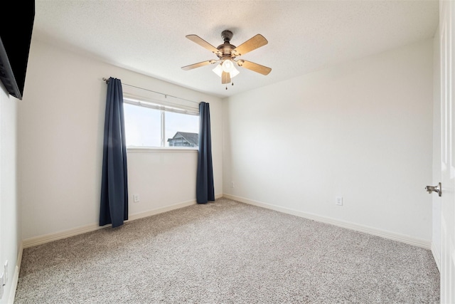 carpeted empty room with a textured ceiling and ceiling fan