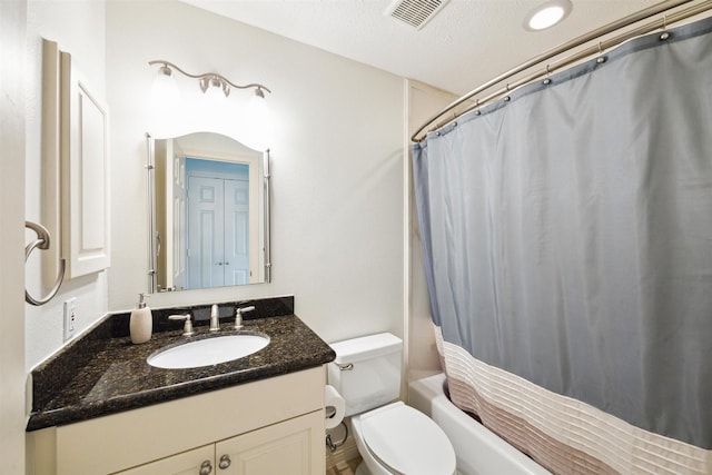 full bathroom featuring vanity, shower / tub combo, a textured ceiling, and toilet