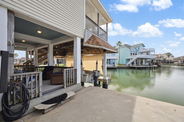 view of patio featuring a boat dock and a water view