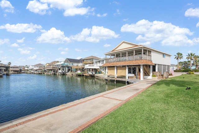 view of dock featuring a yard and a water view