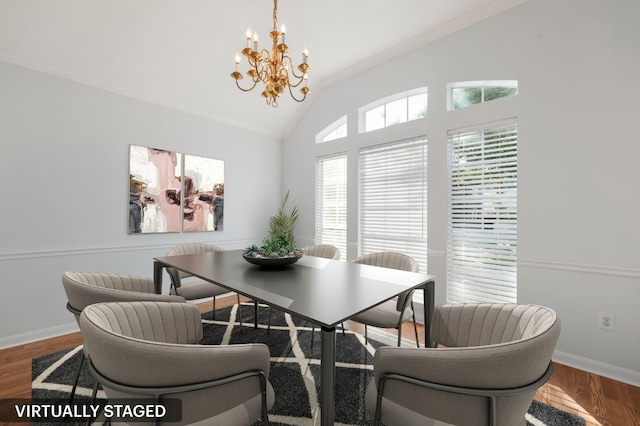 dining area with hardwood / wood-style floors, lofted ceiling, crown molding, and an inviting chandelier