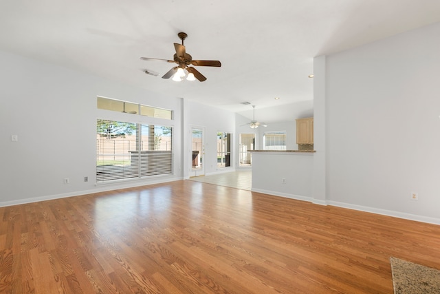 unfurnished living room with ceiling fan and light wood-type flooring