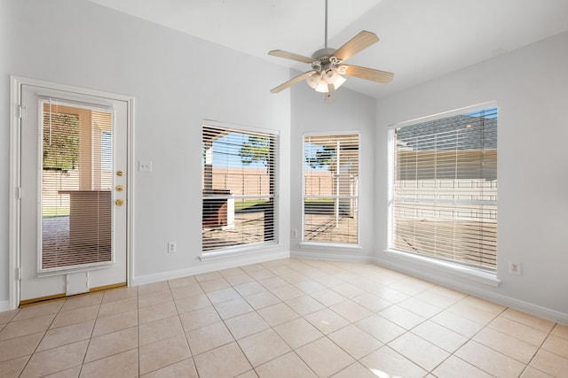 unfurnished dining area featuring ceiling fan, light tile patterned flooring, and lofted ceiling