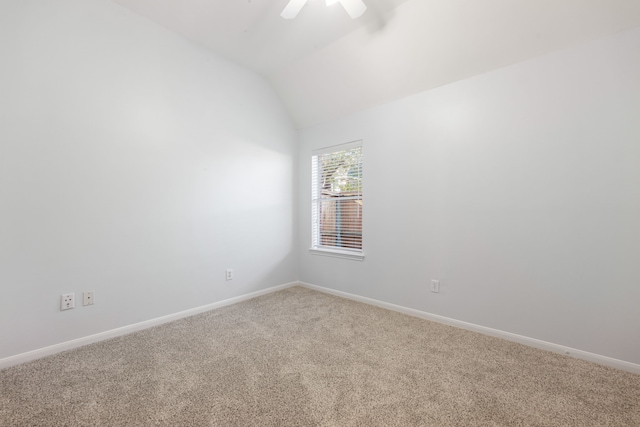 empty room featuring carpet flooring, ceiling fan, and lofted ceiling