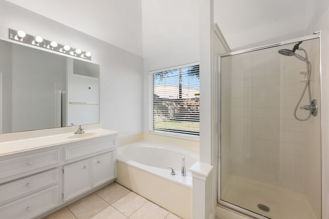 bathroom with tile patterned floors, vanity, and plus walk in shower