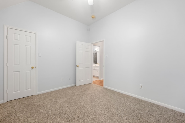 spare room with light carpet and high vaulted ceiling