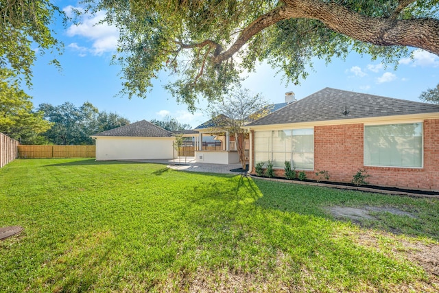 back of house featuring a yard and a patio area