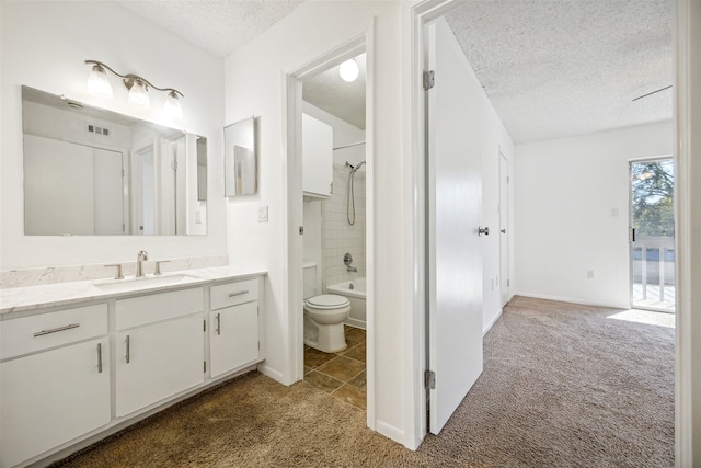 full bathroom with vanity, tiled shower / bath, tile patterned flooring, toilet, and a textured ceiling