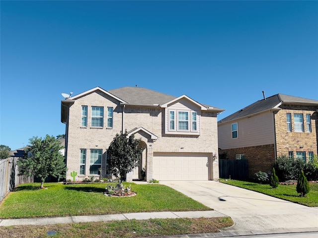 view of property with a garage and a front lawn