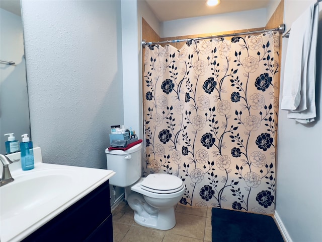 bathroom with tile patterned floors, vanity, toilet, and curtained shower