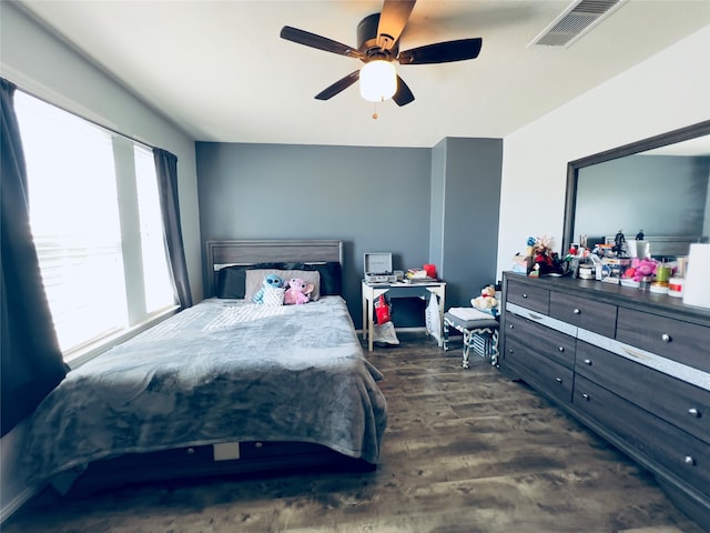 bedroom with ceiling fan and dark wood-type flooring