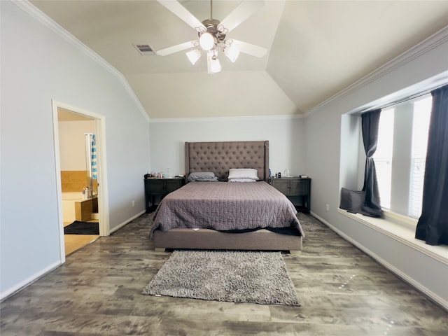 bedroom featuring hardwood / wood-style floors, ceiling fan, ensuite bath, and vaulted ceiling