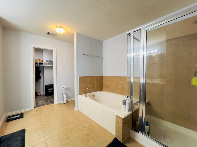 bathroom with tile patterned flooring, a textured ceiling, and independent shower and bath