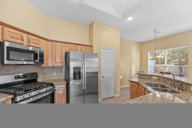 kitchen featuring light stone countertops, sink, a chandelier, and appliances with stainless steel finishes