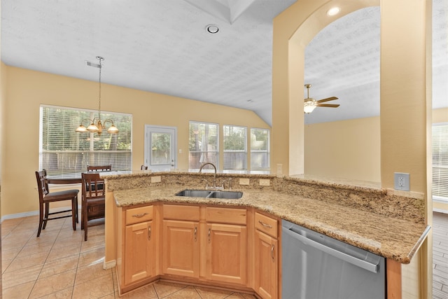 kitchen featuring dishwasher, ceiling fan with notable chandelier, sink, a textured ceiling, and light stone counters