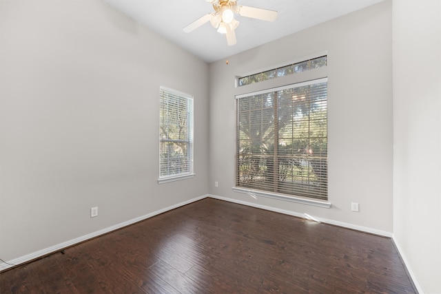 spare room with dark hardwood / wood-style floors and ceiling fan