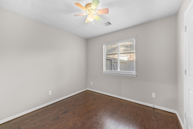 unfurnished room with a textured ceiling, ceiling fan, and dark wood-type flooring