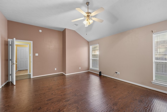 empty room featuring ceiling fan, dark hardwood / wood-style flooring, and lofted ceiling