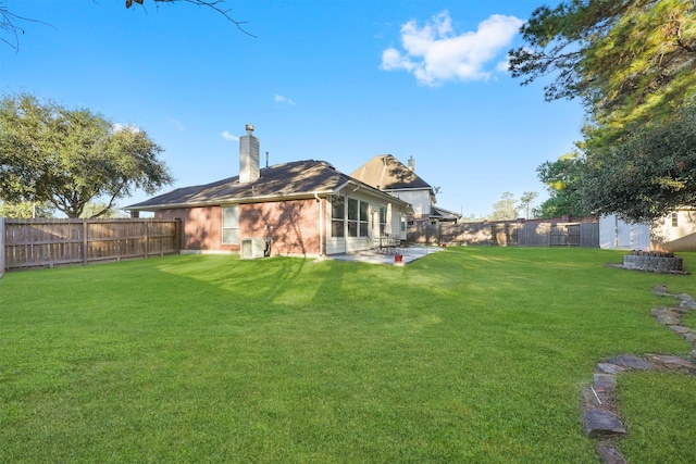 rear view of house featuring a yard and a patio