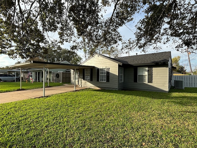 single story home with a front yard, a carport, and cooling unit