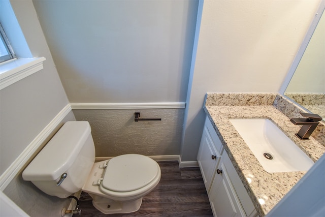 bathroom featuring hardwood / wood-style floors, vanity, and toilet