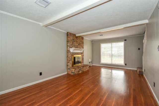 unfurnished living room with ornamental molding, a textured ceiling, beam ceiling, hardwood / wood-style flooring, and a fireplace