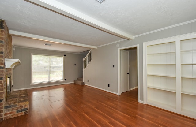 unfurnished living room featuring a fireplace, beam ceiling, dark hardwood / wood-style flooring, and crown molding