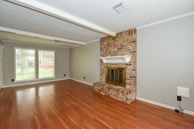 unfurnished living room with hardwood / wood-style flooring, beam ceiling, ornamental molding, and a fireplace