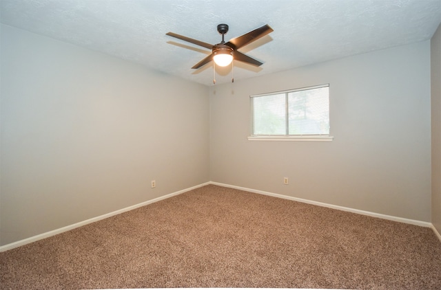 carpeted spare room with a textured ceiling and ceiling fan