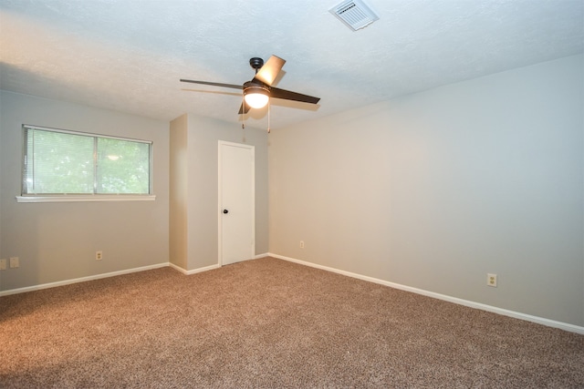 carpeted empty room with a textured ceiling and ceiling fan