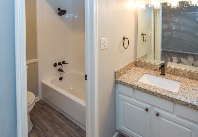 full bathroom featuring vanity, toilet, wood-type flooring, and tiled shower / bath