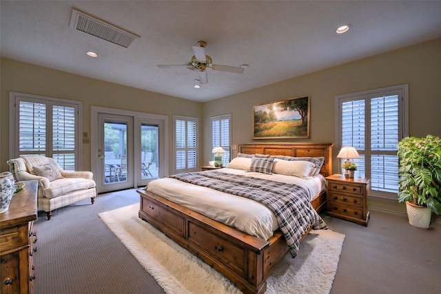 bedroom featuring access to exterior, light colored carpet, and ceiling fan