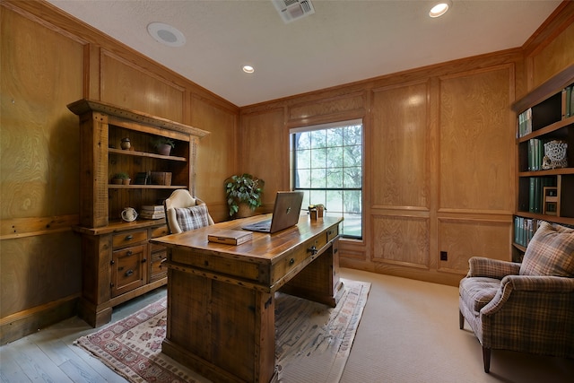 office space with light hardwood / wood-style floors and wood walls