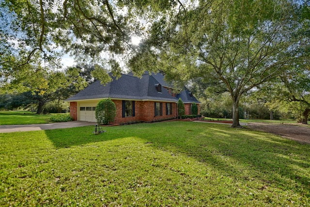 view of front of property with a front lawn and a garage