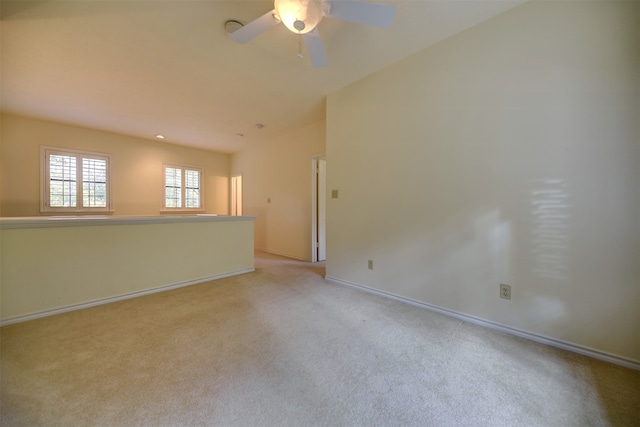 spare room with light carpet and ceiling fan