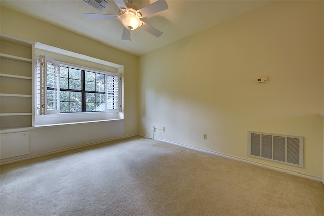 unfurnished room featuring ceiling fan and light colored carpet