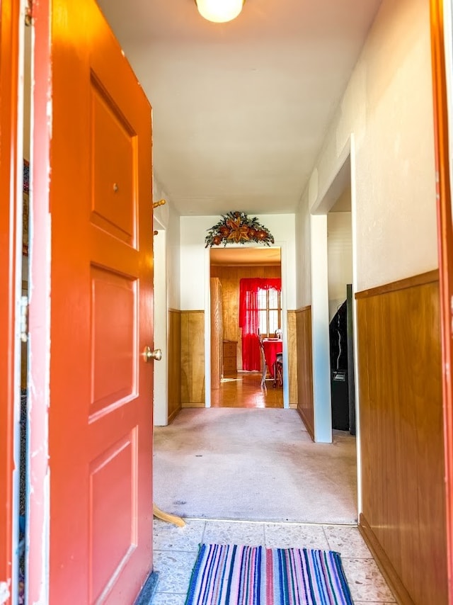 hall featuring wood walls