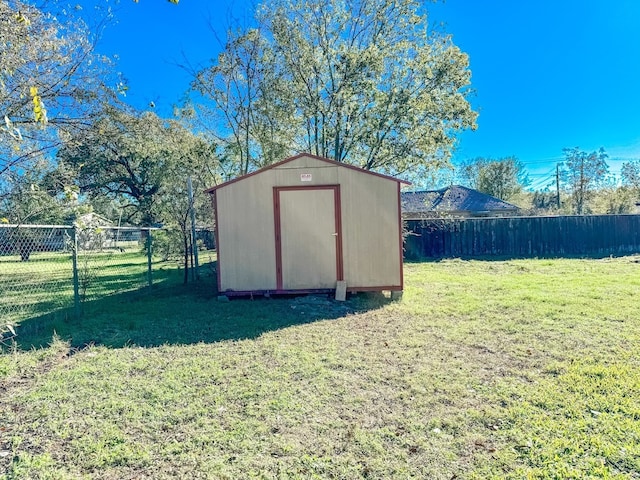 view of outbuilding with a yard