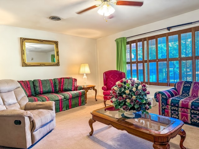 carpeted living room featuring ceiling fan