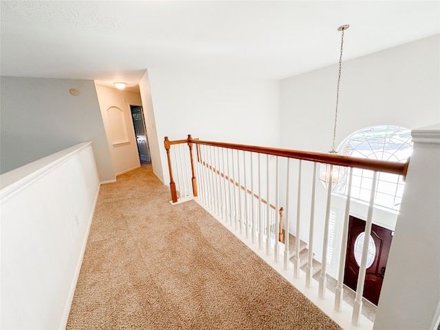 corridor with light colored carpet