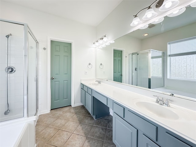 bathroom with tile patterned floors, vanity, and separate shower and tub