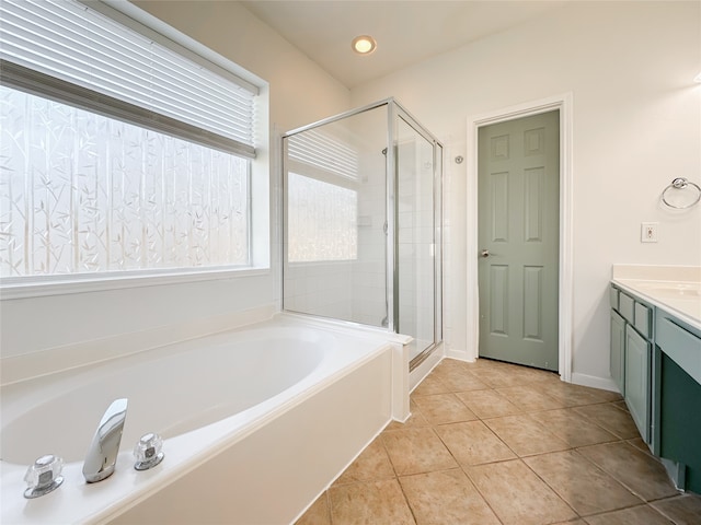 bathroom with tile patterned floors, vanity, and plus walk in shower