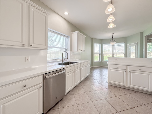 kitchen featuring dishwasher, sink, white cabinets, decorative light fixtures, and light tile patterned floors